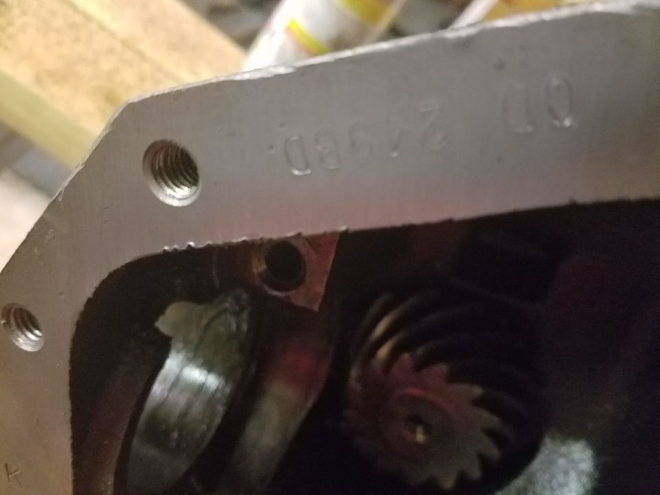 Metal housing part with stamped text "OD 249BD."