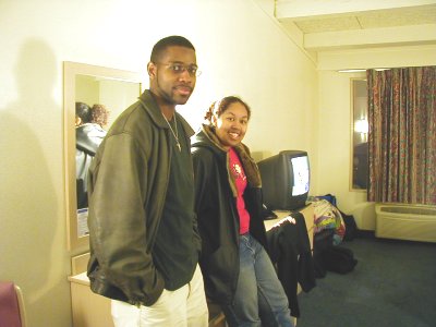 1997 Ford Taurus - A man and woman pose for a photo in a hotel room, with a television and luggage visible in the background.