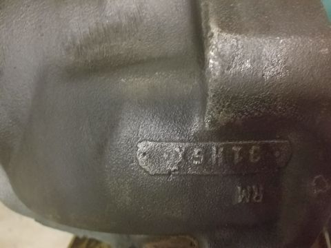 1996 Ford Bronco - Close-up of a cast iron part showing stamped identification numbers and letters.