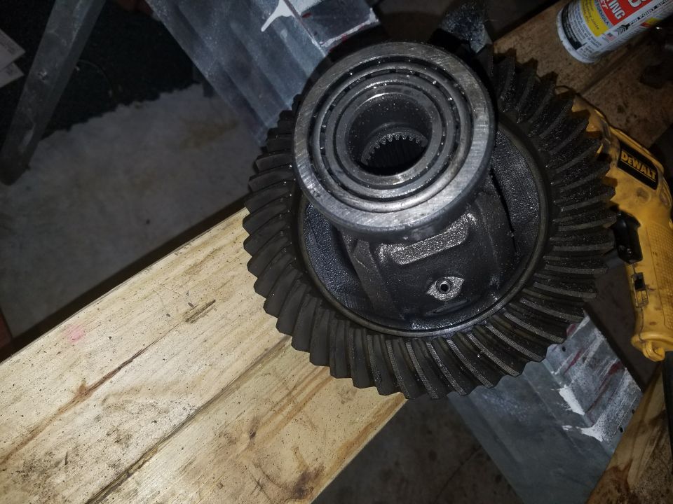 Differential gear with bearing, on wood planks, with DeWalt tool.