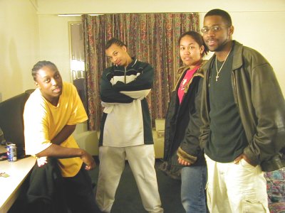 1997 Ford Taurus - Four individuals pose for a photo indoors, with a desk and curtains visible in the background.