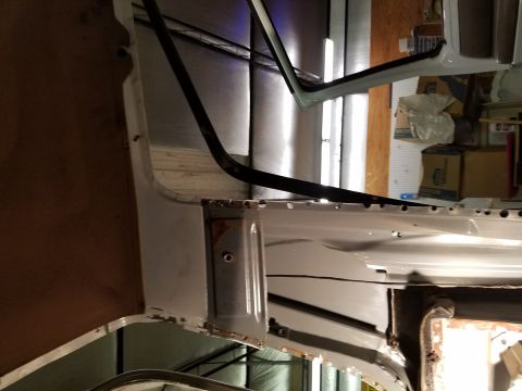 1996 Ford Bronco - The interior of a vehicle undergoing restoration, showing exposed metal panels and some rust around the door frame. The vehicle appears to…