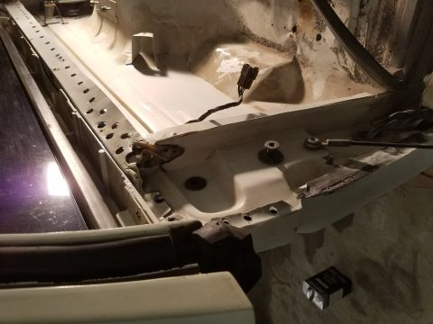 1996 Ford Bronco - This is a close-up view of the interior of a vehicle's body, likely the driver's side rocker panel area, showing exposed metal, wiring, and…