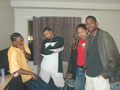 1997 Ford Taurus - A group of four individuals pose for a photo indoors, with a SuperMotors.net watermark visible in the lower right corner.
