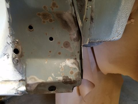 1996 Ford Bronco - Close-up view of a vehicle's metal frame showing signs of rust and corrosion.