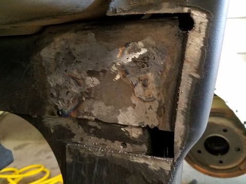 1996 Ford Bronco - Metal frame section shows evidence of repair work with visible welds and grinding.