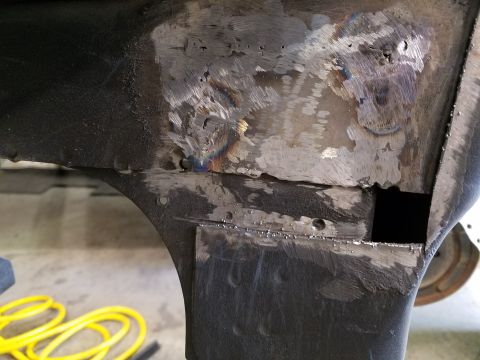 1996 Ford Bronco - This image shows a section of vehicle bodywork that has been repaired with welding and grinding.
