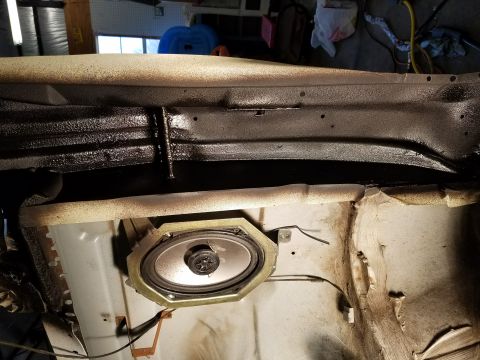 1996 Ford Bronco - Speaker installed in a vehicle's interior panel, with visible wiring and structural components.