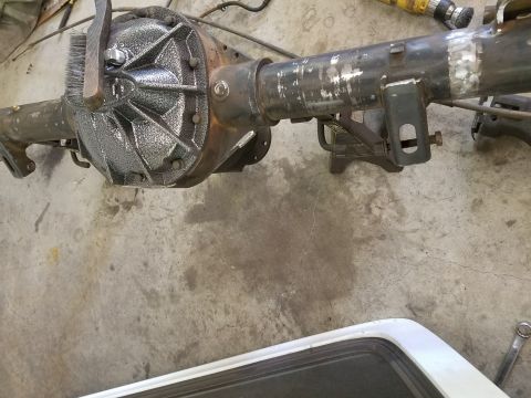 1996 Ford Bronco - A rear axle assembly is shown on a concrete floor, appearing to be undergoing maintenance or repair.