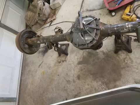 1996 Ford Bronco - A rear axle assembly, likely from a truck or SUV, is shown disassembled and resting on jack stands.