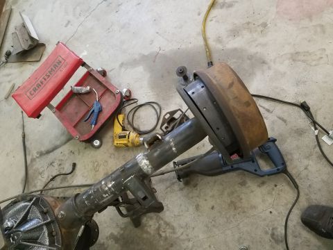 1996 Ford Bronco - Automotive rear axle assembly and various tools laid out on a workshop floor.