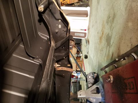 1996 Ford Bronco - The interior door panel and frame of a vehicle are visible, along with the underside of the chassis.