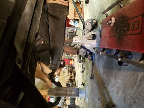 1996 Ford Bronco - Vehicle under repair, viewed from below with suspension components visible.