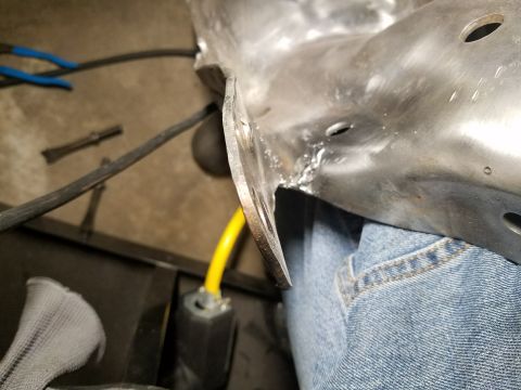 1996 Ford Bronco - Metal bracket with wires and a yellow power cord visible in a workshop setting.