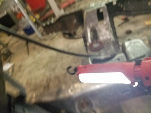 1996 Ford Bronco - Interior view of a vehicle with a red work light illuminating the metal floor.