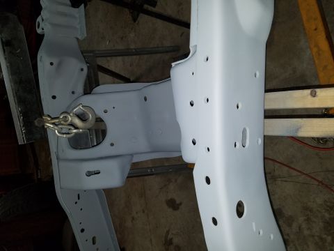 1996 Ford Bronco - A vehicle frame, recently painted, is shown with a tow hook assembly attached to the front.