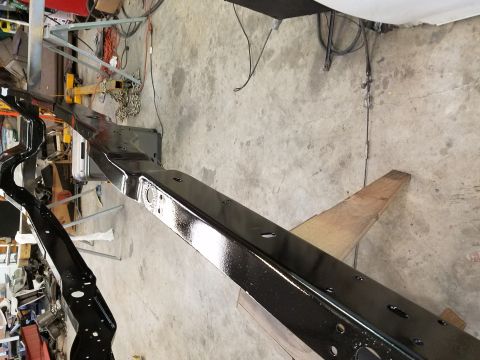 1996 Ford Bronco - A vehicle frame is shown after being painted black.