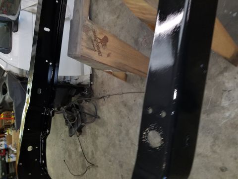 1996 Ford Bronco - Close-up of black painted frame components, possibly undergoing restoration or repair.