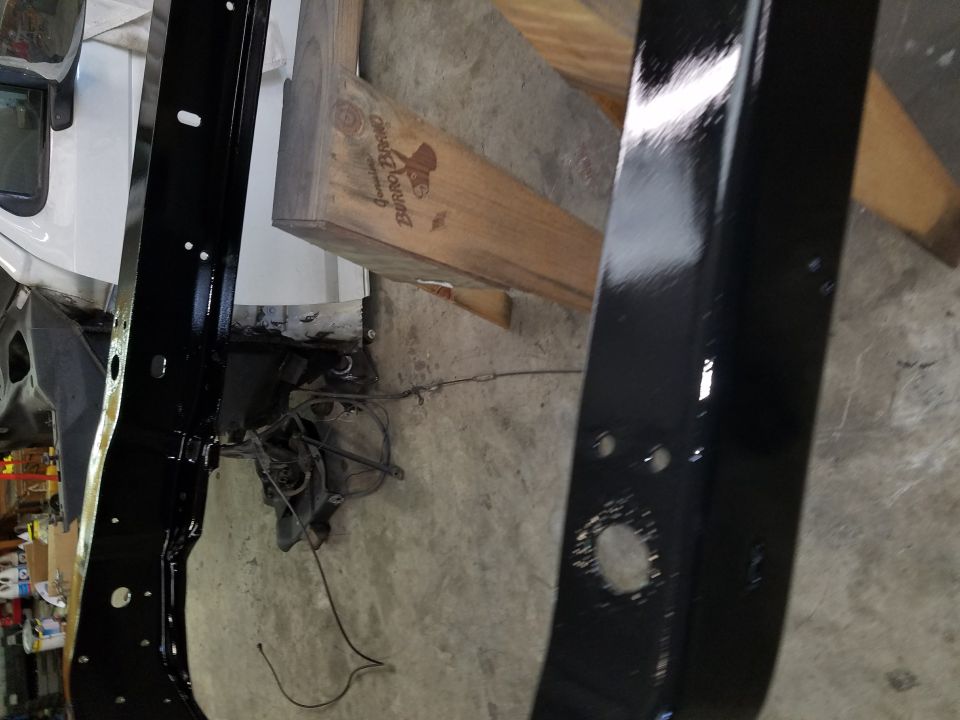 Black painted frame sections with visible bolts and wiring
