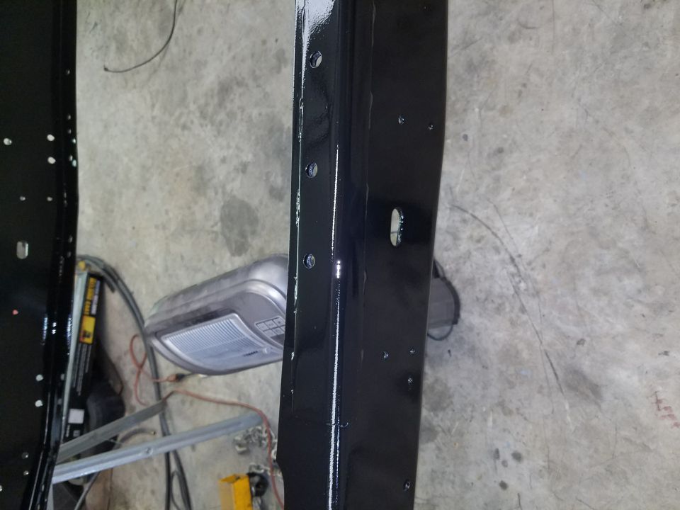 Black painted metal frame with visible bolt holes and a circular cutout
