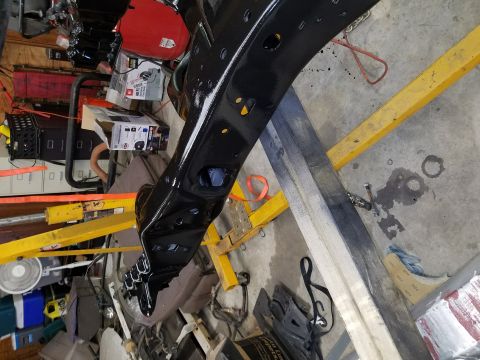 1996 Ford Bronco - A close-up view of a freshly painted vehicle frame component resting on an engine hoist.