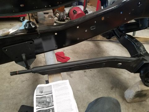 1996 Ford Bronco - The image shows a close-up view of a vehicle's frame and suspension parts, with some paperwork on the floor.