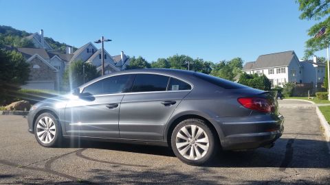 2010 Volkswagen Passat - Side view of a gray Volkswagen sedan with tinted windows and a rear spoiler.