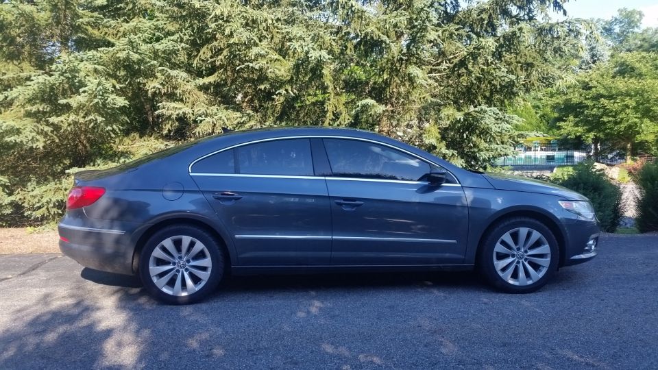 Dark gray Volkswagen CC parked outside. Side view shows the sloping roofline and alloy wheels