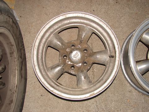 1973 Ford Ranchero - A single silver American Racing wheel is shown, with another wheel partially visible to the right and a tire to the left.