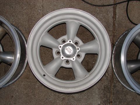 1973 Ford Ranchero - A close-up view of several car wheels, including one with an American Racing center cap.