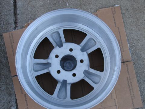 1973 Ford Ranchero - A single aluminum wheel is shown, placed on a piece of cardboard.