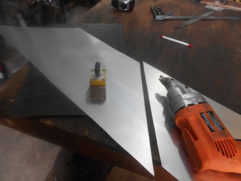 1992 Ford Bronco - Metal sheets are being worked on with a magnetic base and a power tool on a workbench.