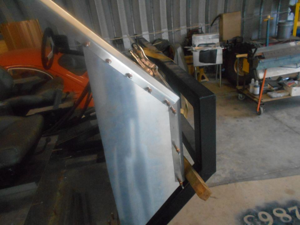 Interior view of a vehicle with a metal panel attached to the door frame