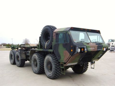 1992 Ford Bronco - This heavy-duty military tractor truck features a distinctive camouflage pattern and a large spare tire.