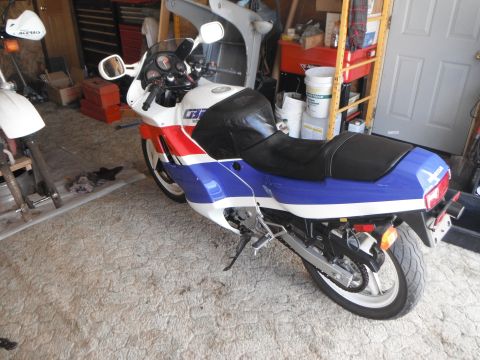 1989 Honda CBR600F - A red, white, and blue 1989 Honda CBR600F motorcycle is parked in a garage.