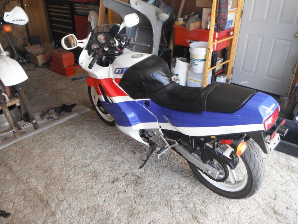 1989 Honda CBR600F in a garage with tools and shelves in the background
