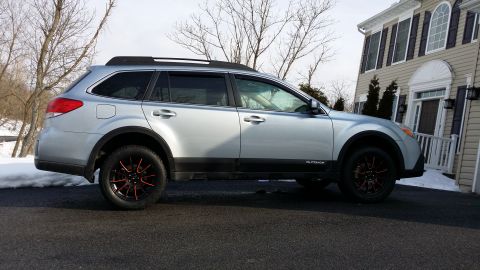 2014 Subaru Outback - Side view of a silver Subaru Outback, likely from the 2010-2014 generation, aftermarket wheels.