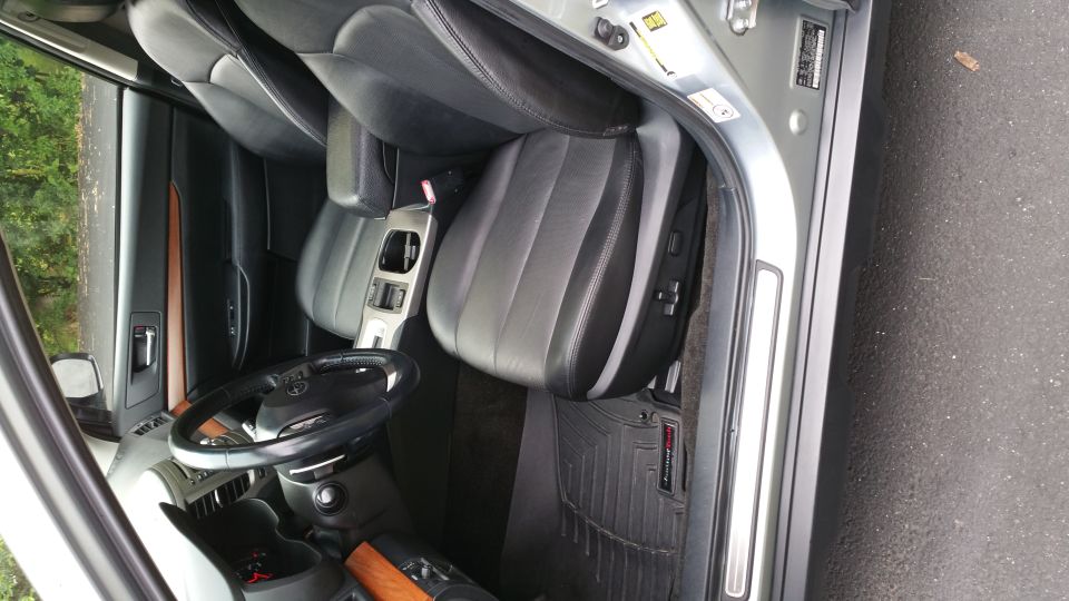 2014 Subaru Outback interior showing front seats, steering wheel, and center console