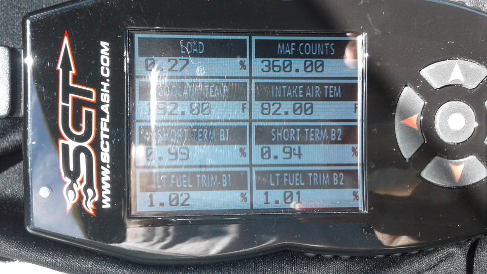 SCT handheld tuner screen showing engine load, MAF counts, and fuel trim data