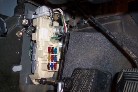 1993 Toyota Pickup/SR5 - Interior view of a vehicle's fuse box and pedals, showing electrical components and foot controls.