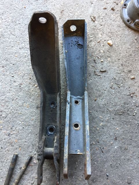 1979 Ford Bronco - Comparison of two automotive suspension brackets, one showing significant wear and the other appearing recently refurbished.