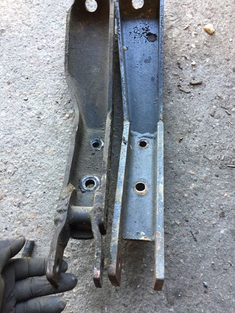 1979 Ford Bronco - Comparison of two metal suspension components, one appearing older and more worn than the other.