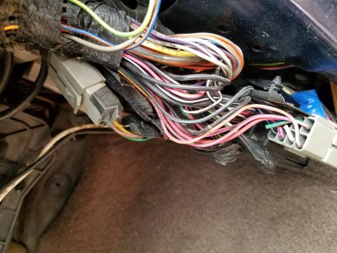 1994 Ford Bronco - Close-up of a complex vehicle wiring harness with many colored wires and connectors.