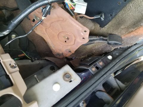 1994 Ford Bronco - Interior view of vehicle floor with pedals and exposed wiring.