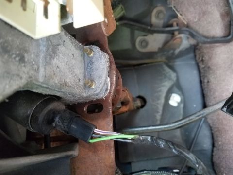1994 Ford Bronco - Close-up of the wiring harness and metal bracketry inside a 1994 Ford Bronco.