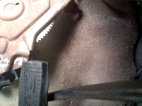 1994 Ford Bronco - The interior floor of a vehicle, showing the carpet and pedals.