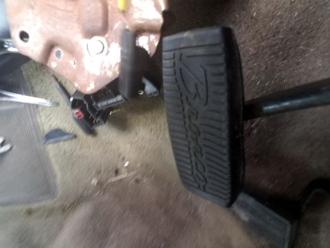 1994 Ford Bronco - The interior of a vehicle shows the brake and gas pedals, with the Ford logo visible on the brake pedal.