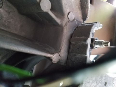1994 Ford Bronco - A close-up view of a metal bracket and bolt, part of a larger mechanical assembly.