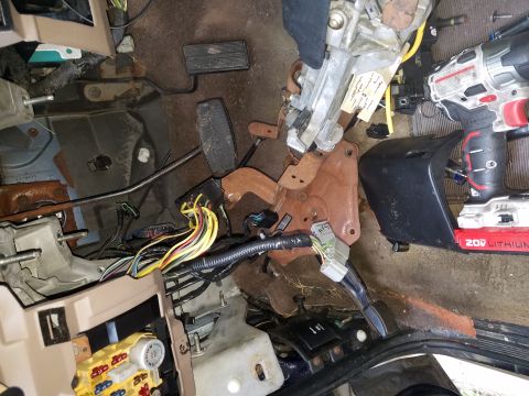 1994 Ford Bronco - The interior of a 1994 Ford Bronco shows exposed wiring and pedals, suggesting a repair or modification is underway.