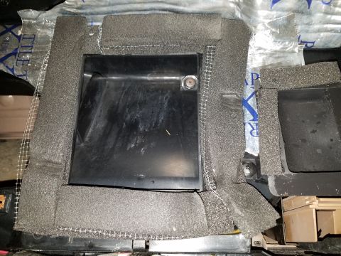 1994 Ford Bronco - A close-up view of a vehicle's dashboard component, covered in foam and mesh material.